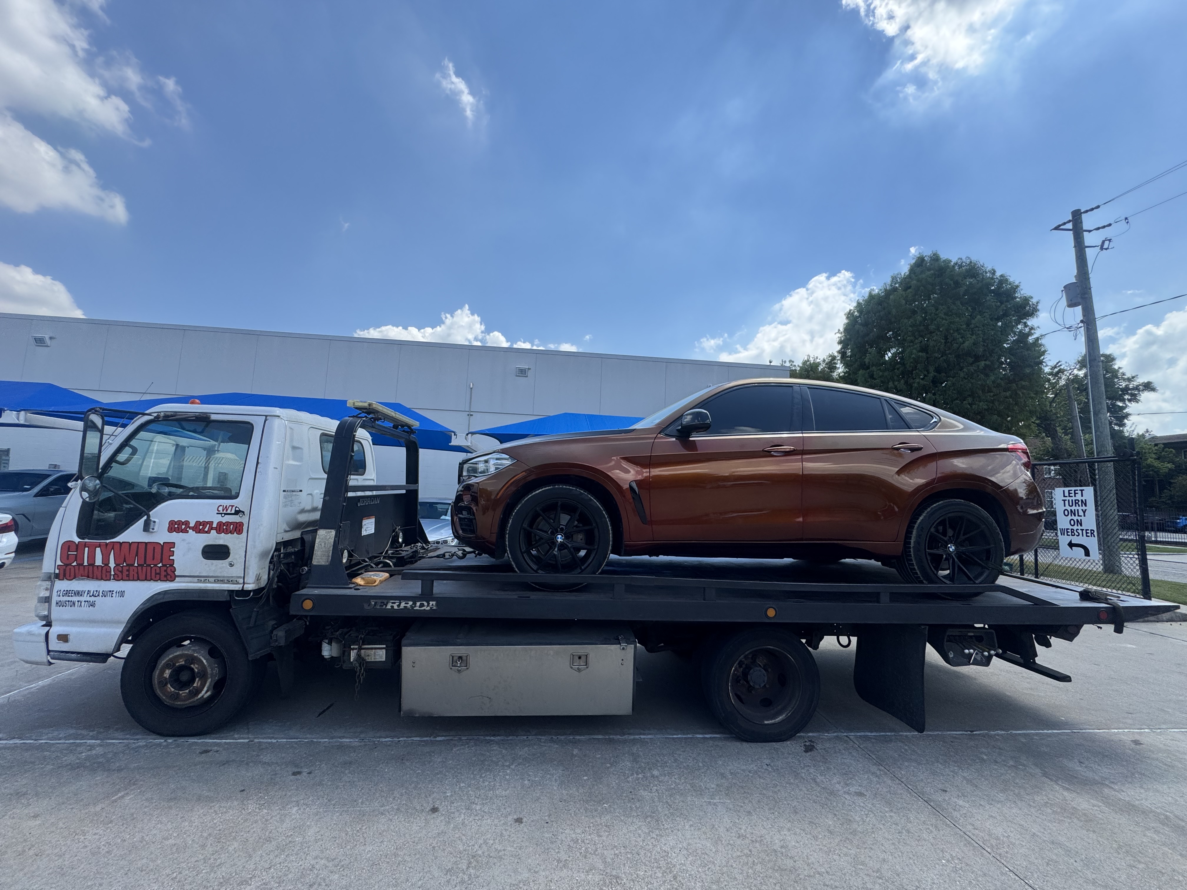 Citywide Towing Services flatbed truck towing a BMW X6 in Houston, TX