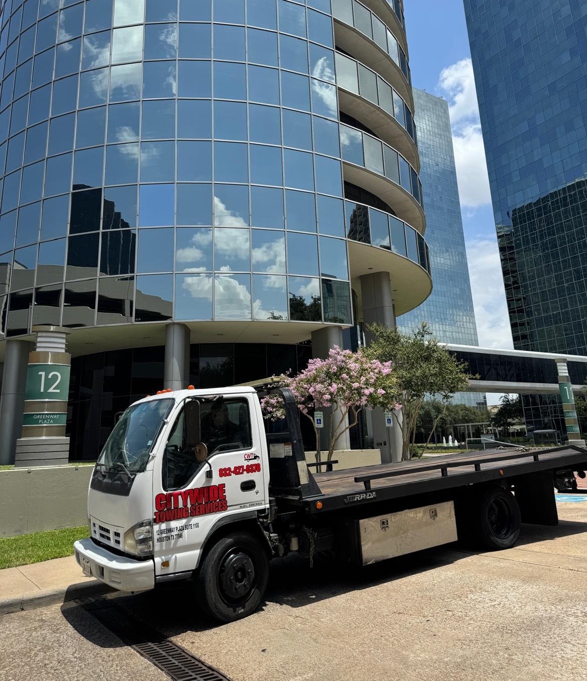 Citywide Towing Services flatbed truck parked at 12 Greenway Plaza, Houston, TX