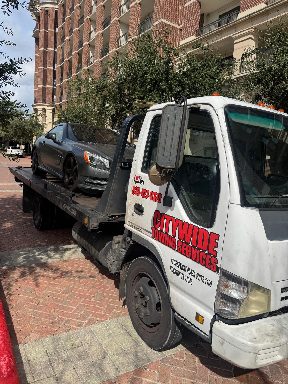 Citywide Towing Services flatbed truck towing a Mercedes-Benz in Houston, TX